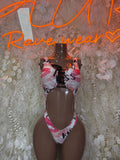 Heart and kiss-print one-piece swimsuit with pink bow ties on mannequin