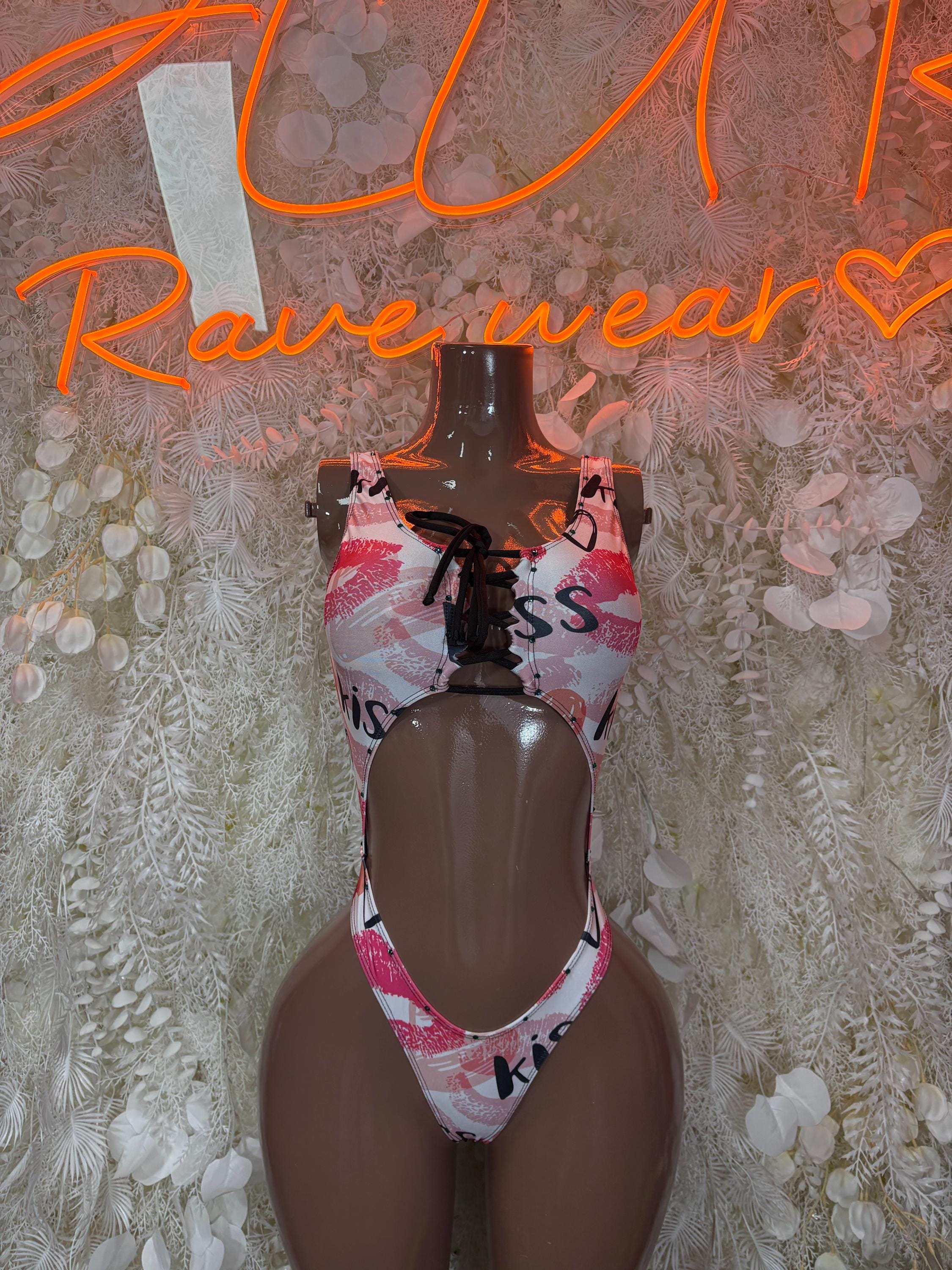 Heart and kiss-print one-piece swimsuit with pink bow ties on mannequin