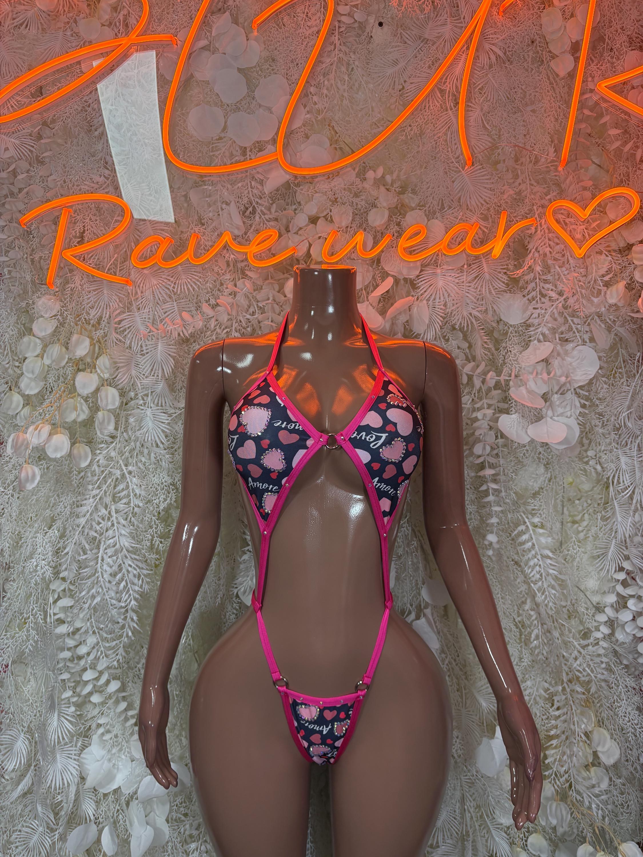 Heart-print lingerie one-piece in black with pink trim and heart bra front
