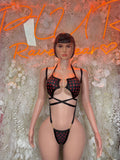 Black heart-print lingerie set with strappy bra and matching thong, front cutout