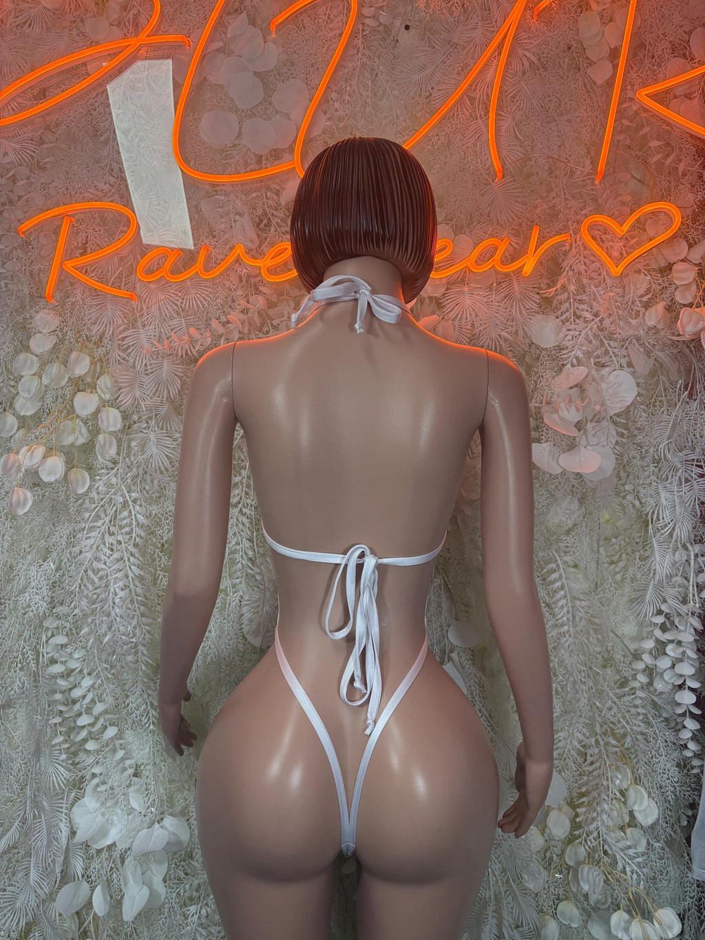 Red heart-print lingerie bodysuit with white trim and tie-back lace closures