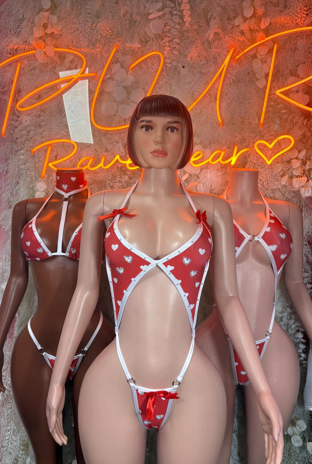 Heart lingerie bodysuit with red heart print, white trim, and thin halter straps