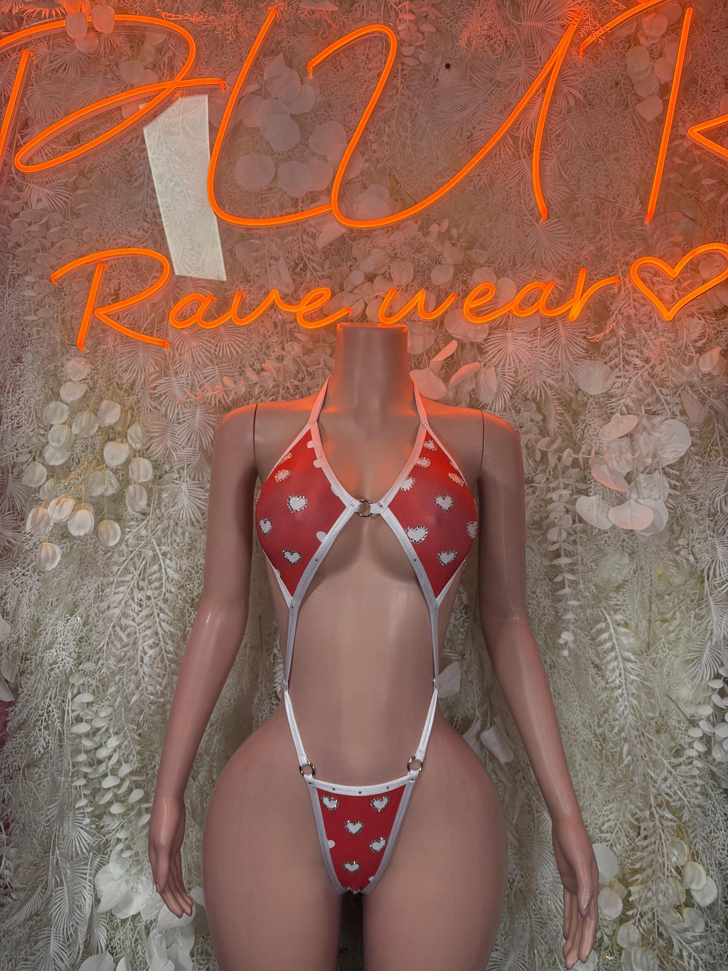 Heart lingerie bodysuit with red heart print and white trim, front cutout and halter