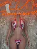 Pink and white lace bodysuit with triangle cups and bow-tied straps, thong bottom