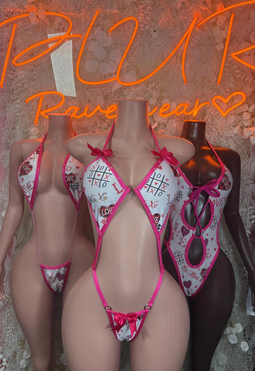 Pink and white patterned lingerie bodysuit with lace trim and shoulder ties