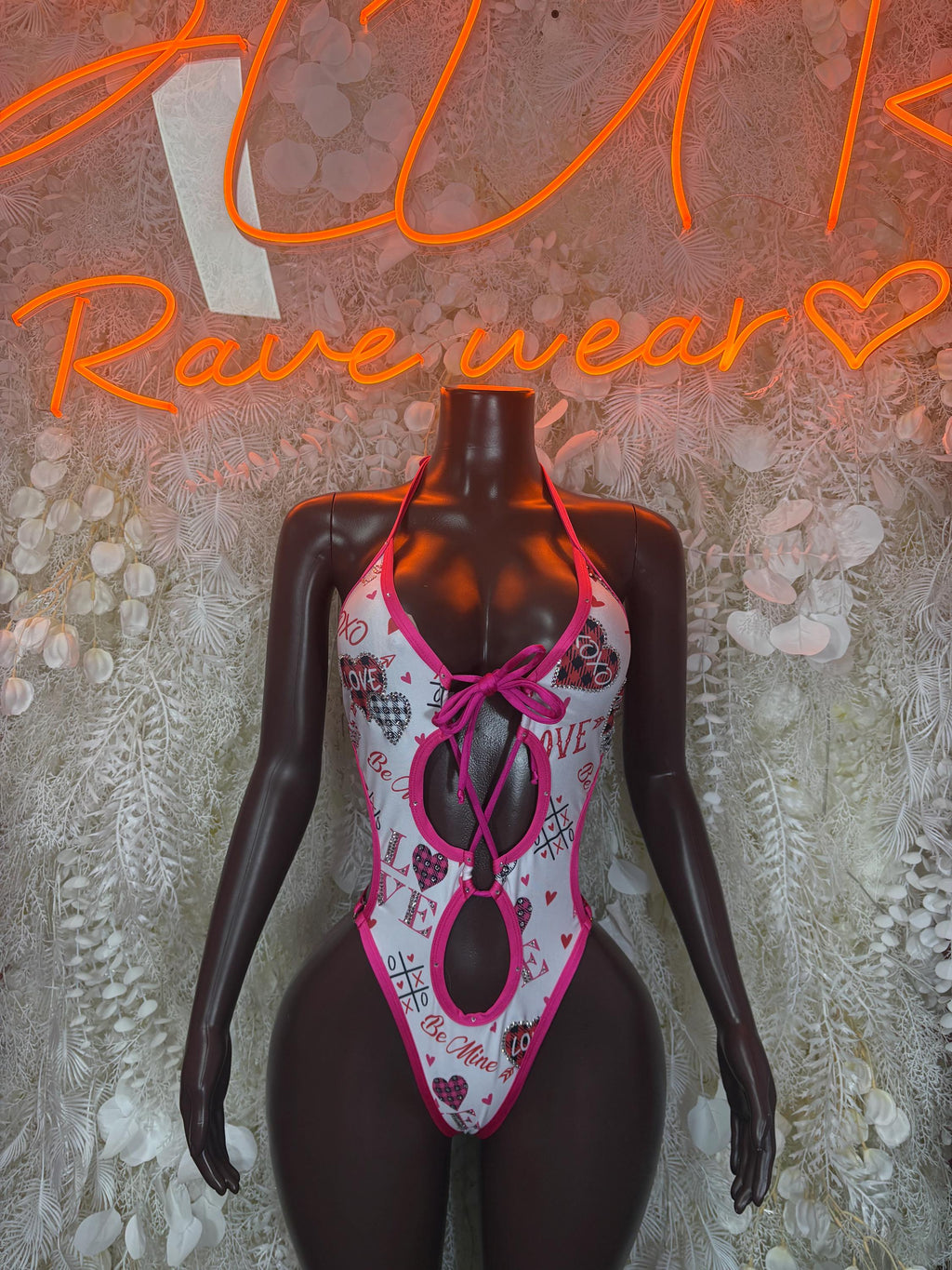 Pink and white patterned lingerie bodysuit with tie straps and cutout front