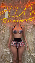 Pink-and-black plaid two-piece set with strappy bra top and pleated mini skirt