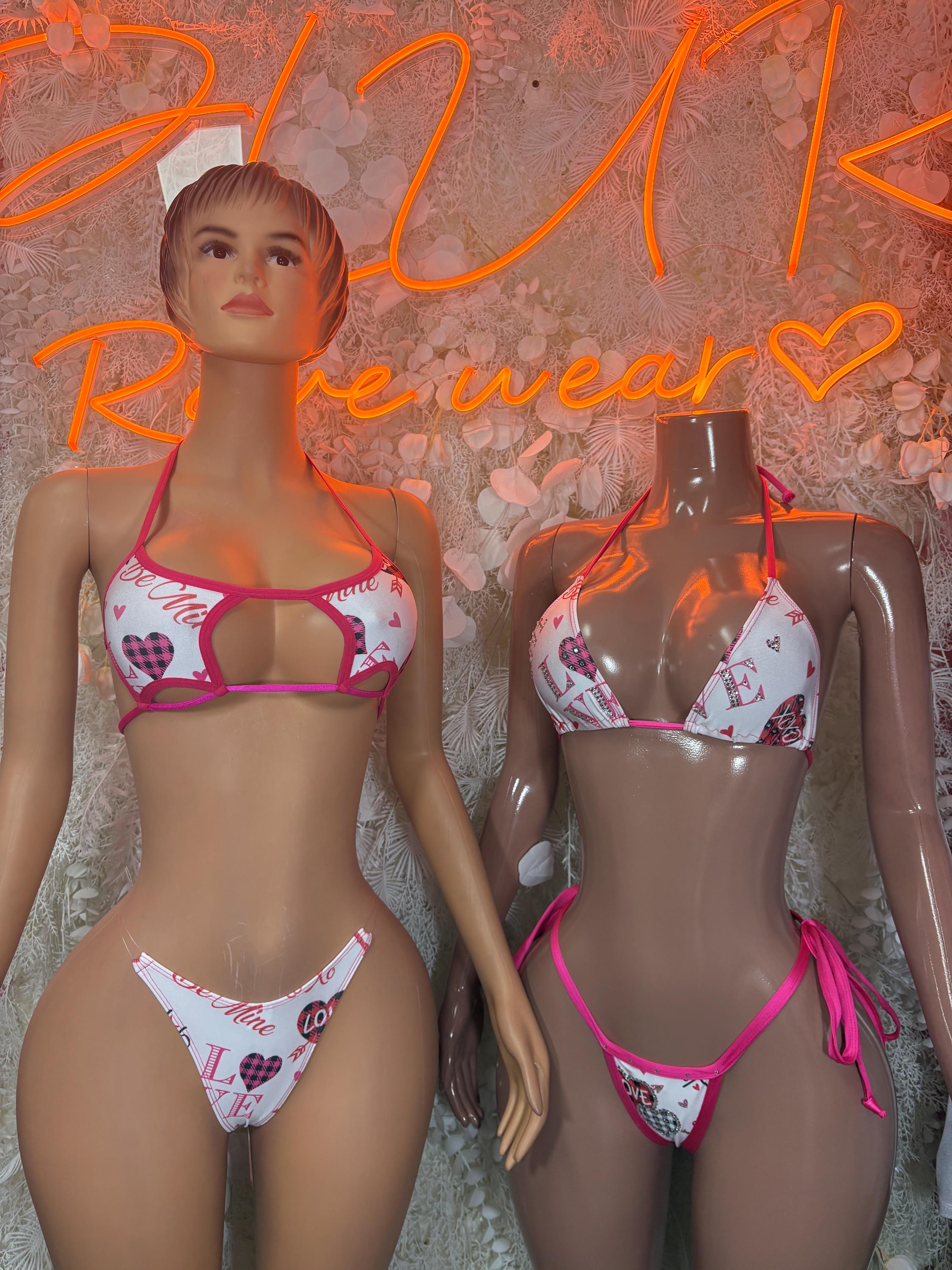 Heart-print bikini set on mannequins: pink trim triangle top and matching bottoms