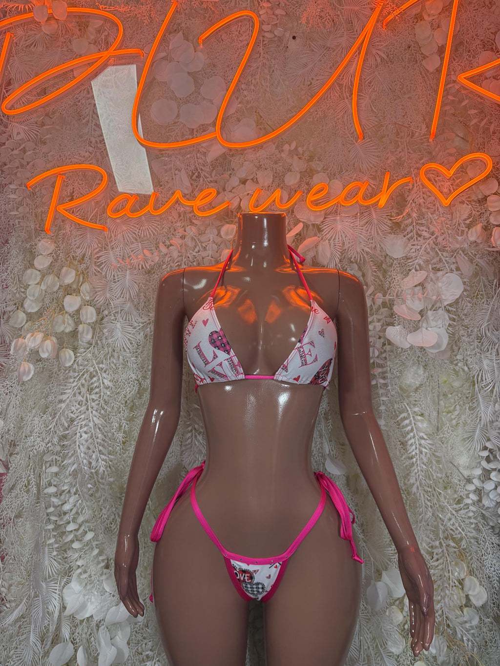 Heart-print bikini set with pink triangle top and tie-front bottoms, white fabric