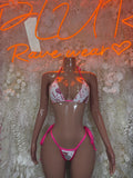 Heart-print bikini set with pink triangle top and tie-front bottoms, white fabric