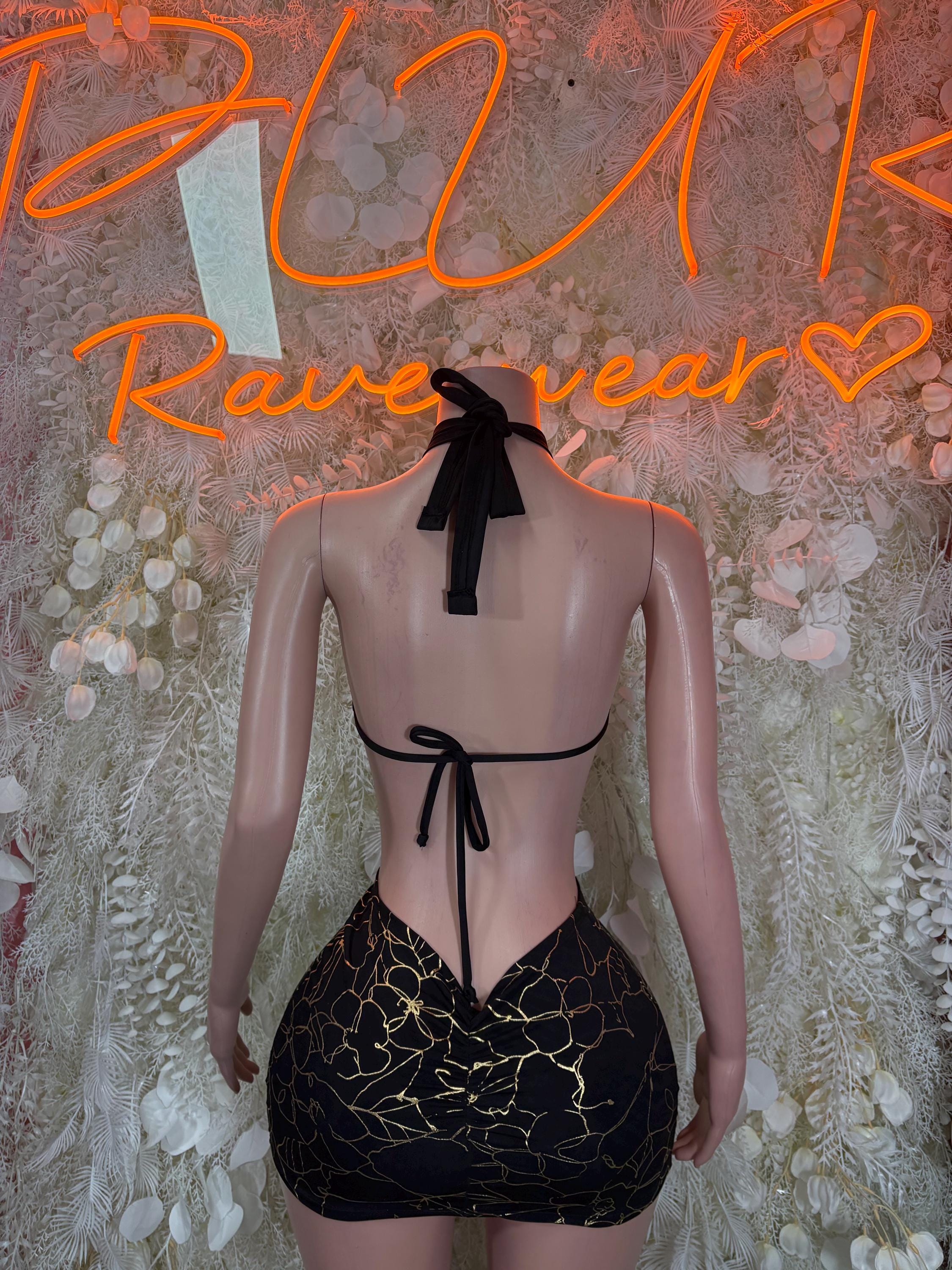 Black backless mini dress with gold line pattern, halter tie and bow at back