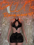 Black mini halter dress with gold line pattern, front cutout and ring detail