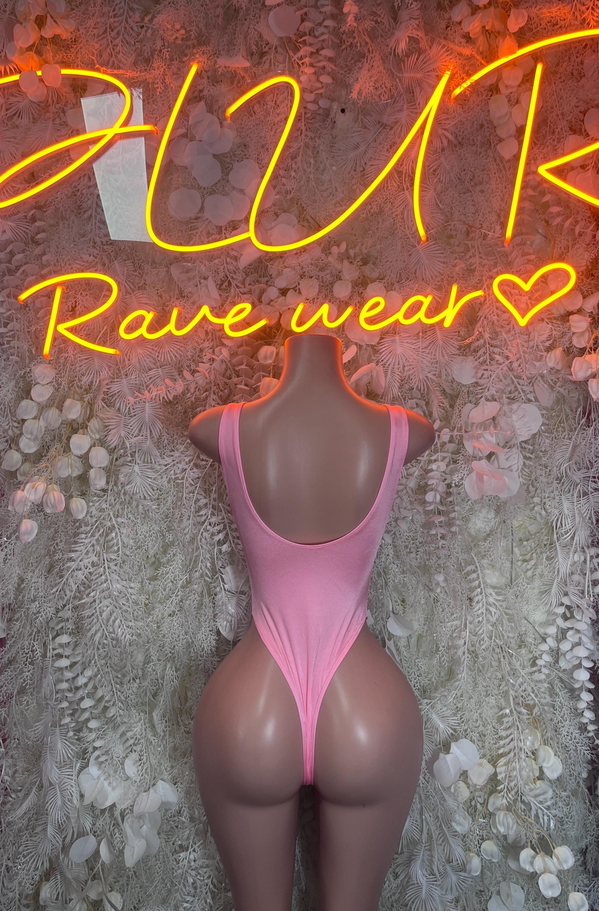 Pink sleeveless one-piece bodysuit on mannequin with open back and cheeky bottom