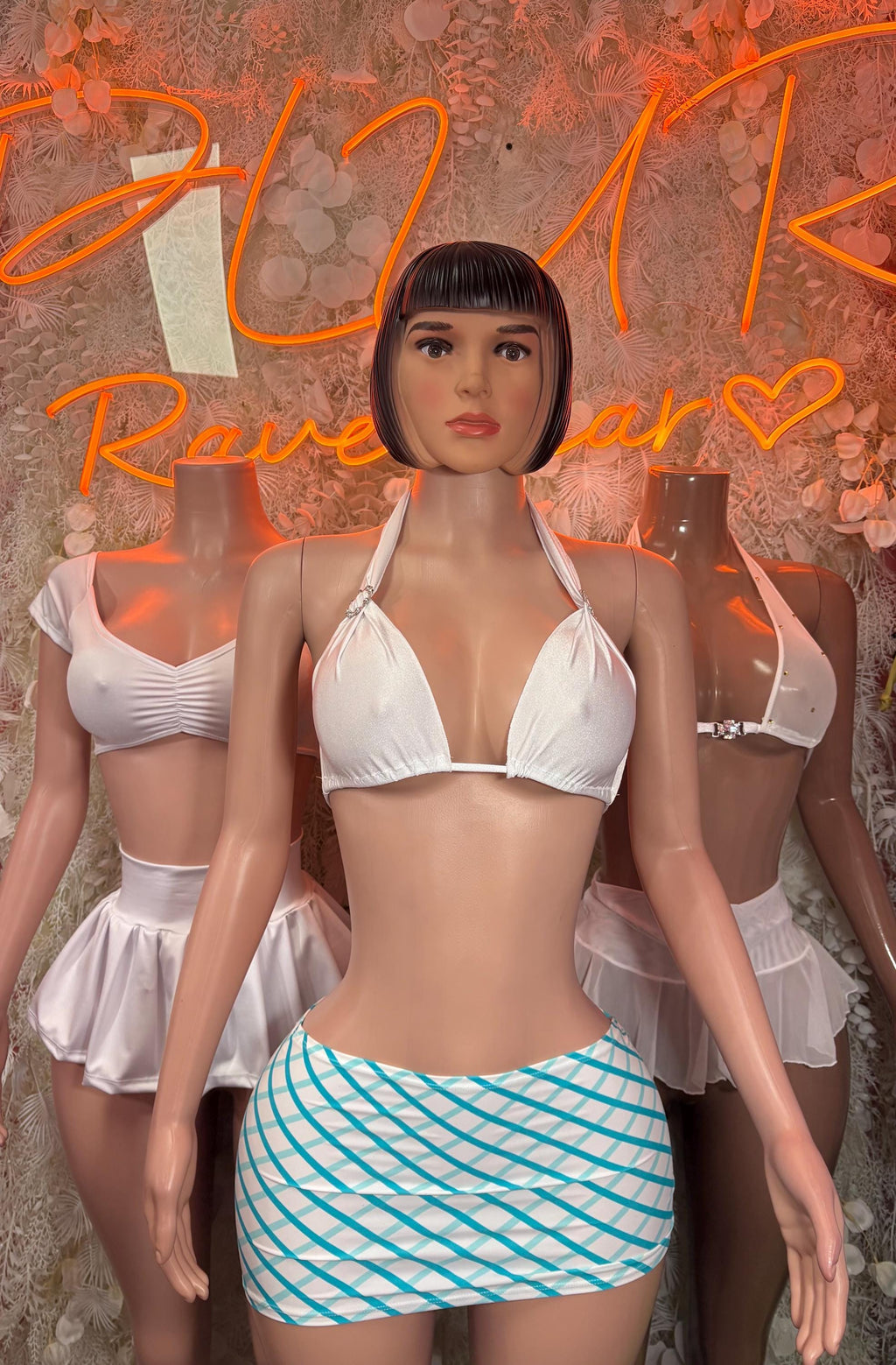 Front view: white halter bikini top paired with blue striped mini skirt