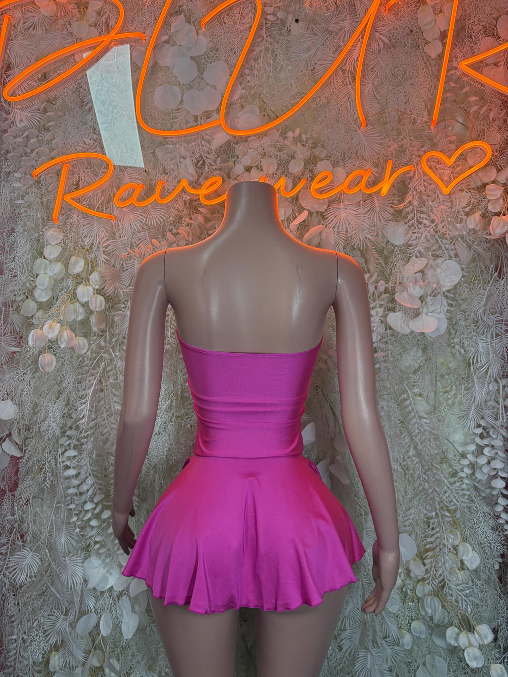 Fuchsia pink one-piece mini dress with ruched bodice and flared skirt, open back