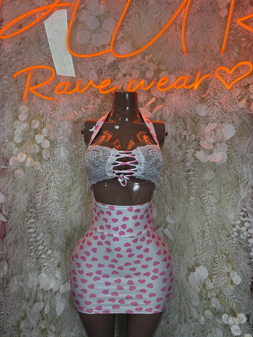 Pink heart mini dress with lace-up black bodice and short heart-pattern skirt