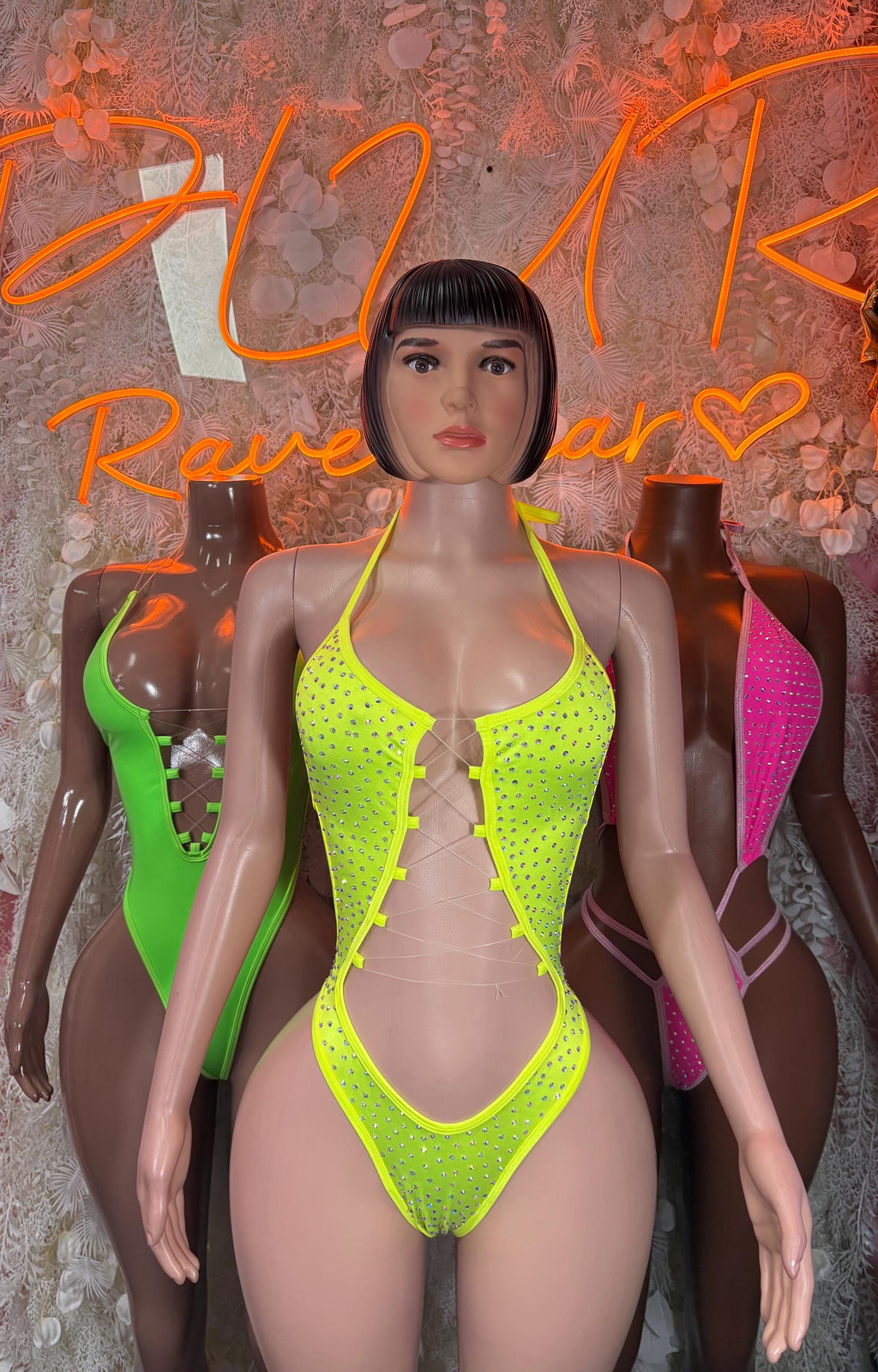 Neon green halter bodysuit with lace-up front and studded texture