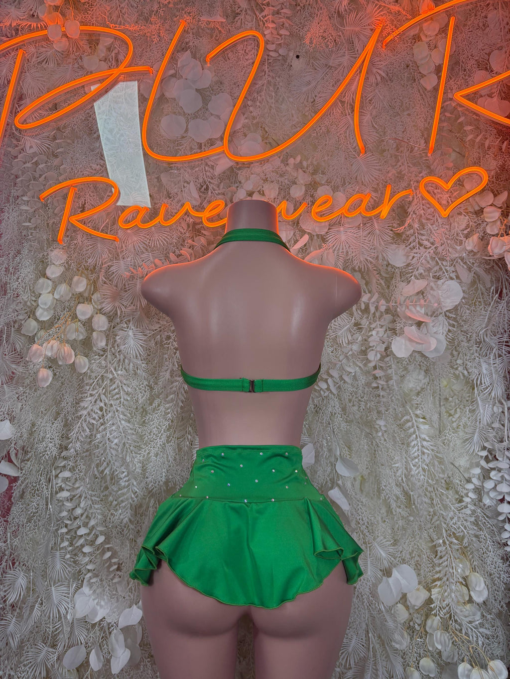 Green ruffle skirt set with halter top, on mannequin back