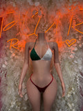 Two-piece bikini: green triangle top, red high-cut bottoms with white tie straps