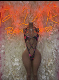 Black heart-print bodysuit with strappy cutouts and pink accents