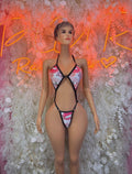 Heart-print lingerie bodysuit with black straps and pink heart cutouts