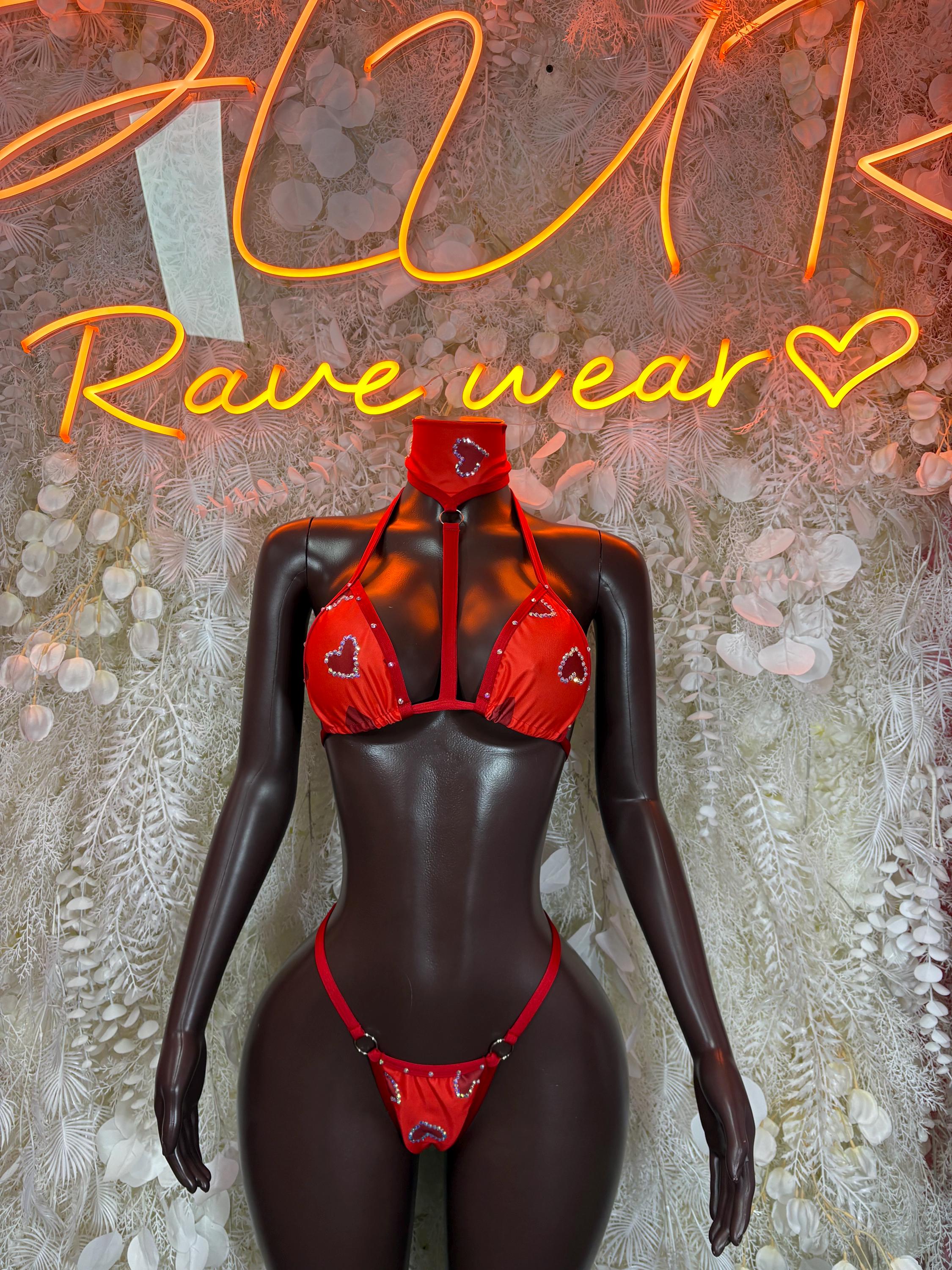 Red heart-pattern bikini set with cutout triangle top and matching bottom on mannequin