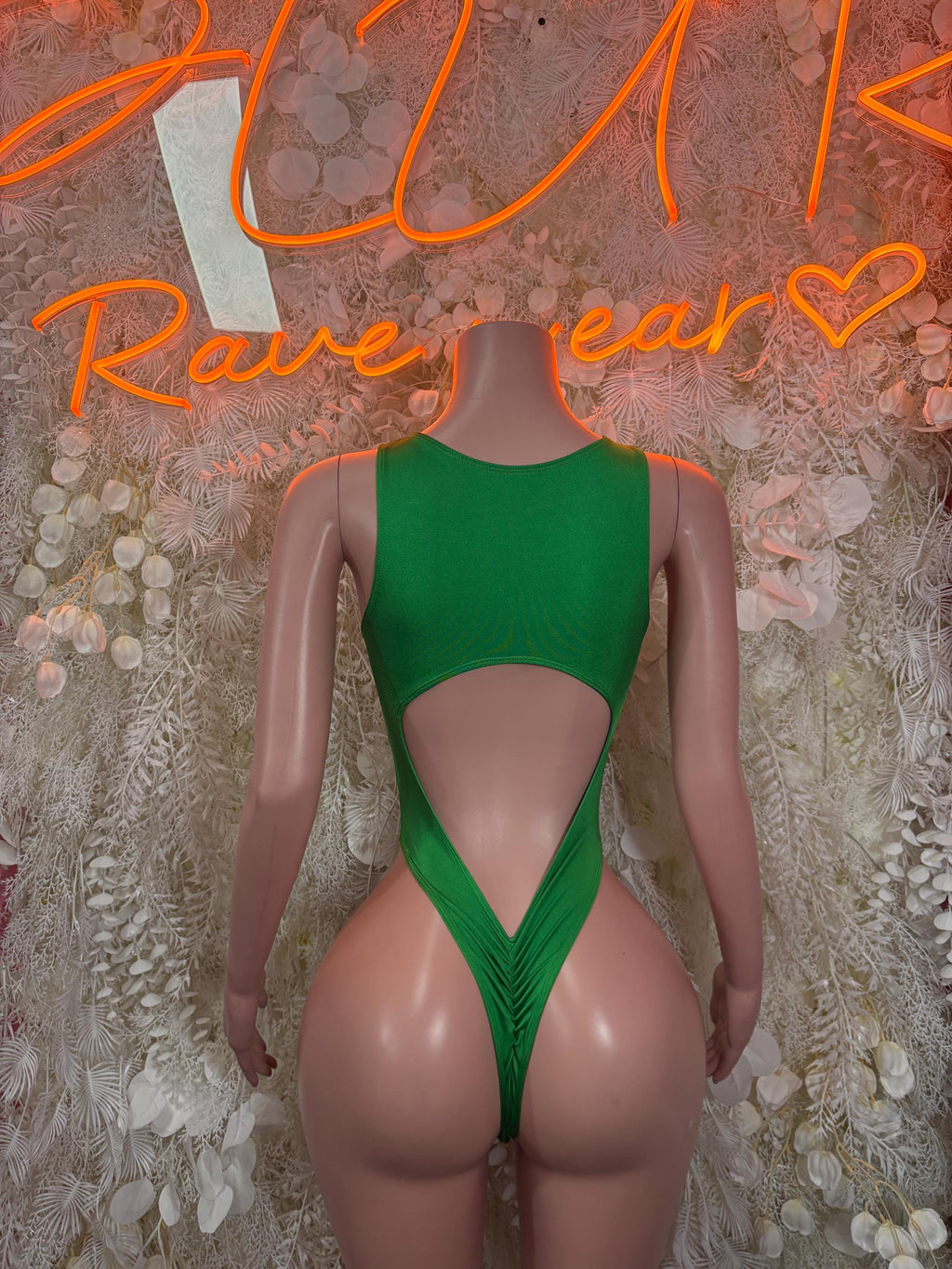 Green backless one-piece bodysuit with teardrop back cutout and high leg