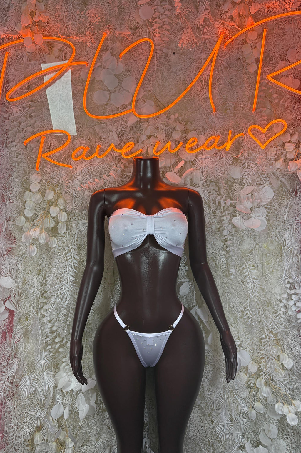 White bikini set with strapless bandeau top and triangle bottoms on mannequin