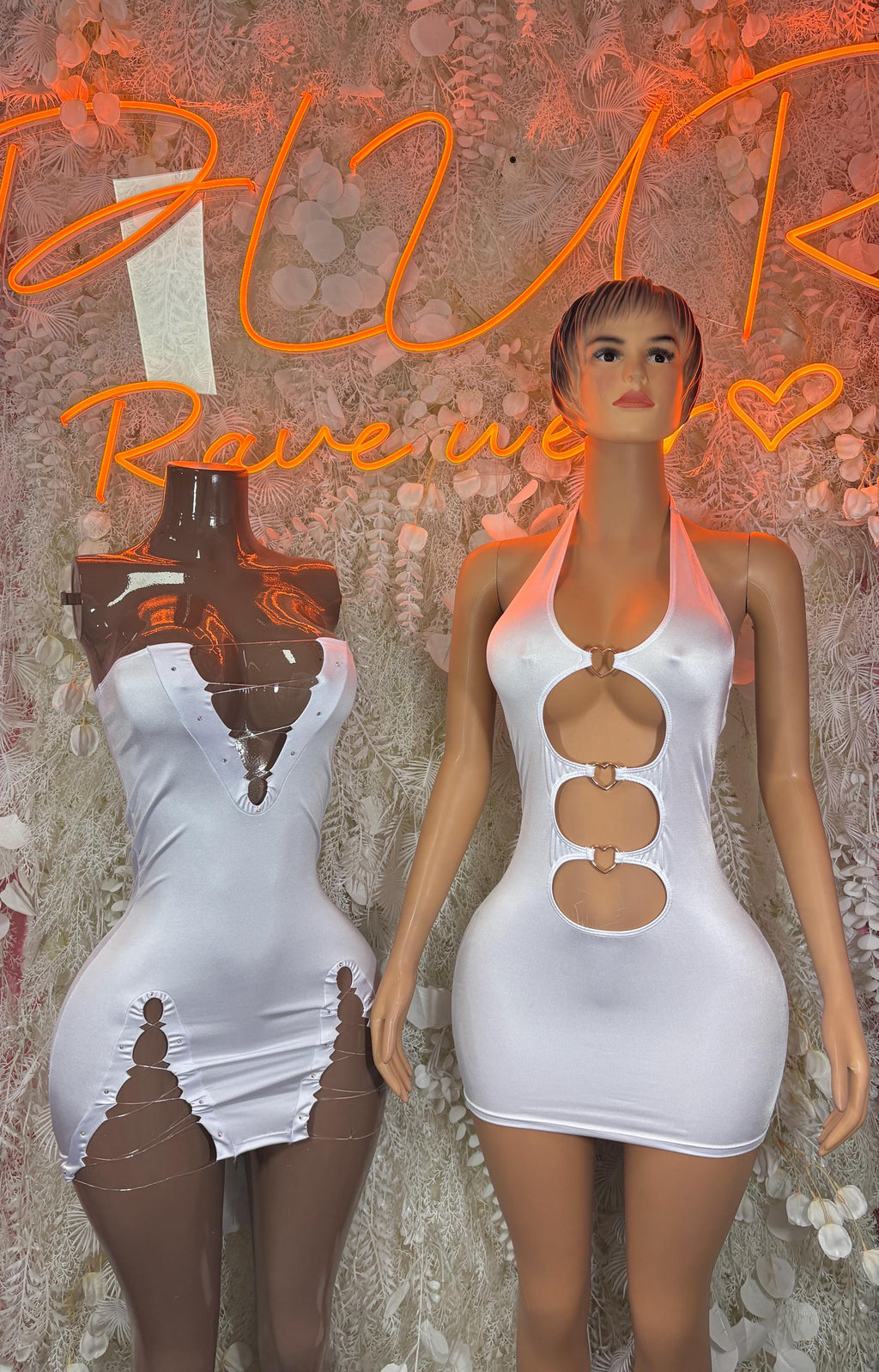 White halter mini dress with circular cutouts and high neckline, sleeveless front style