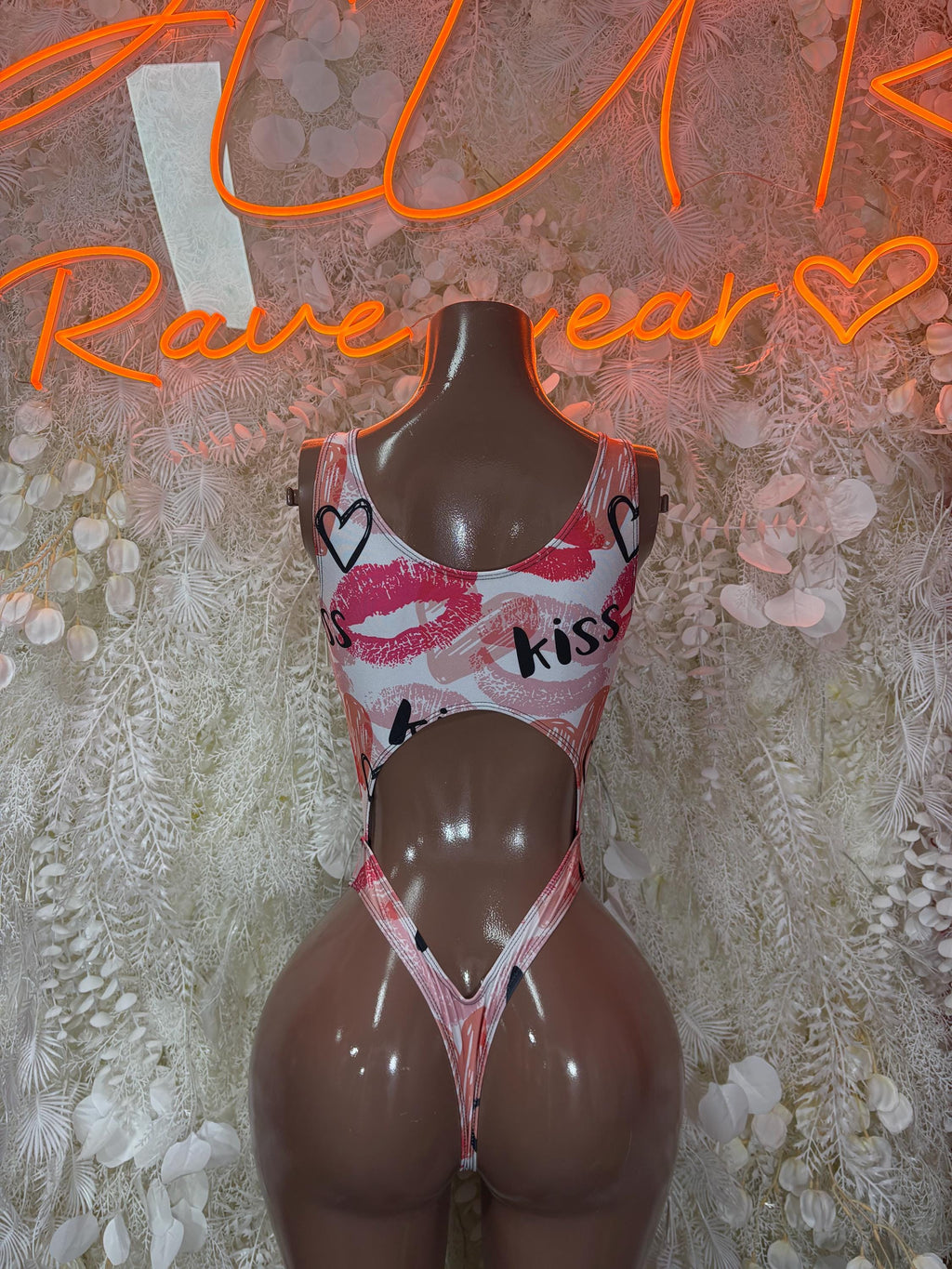 Heart-print one-piece swimsuit with pink high-cut leg and bow-tie straps