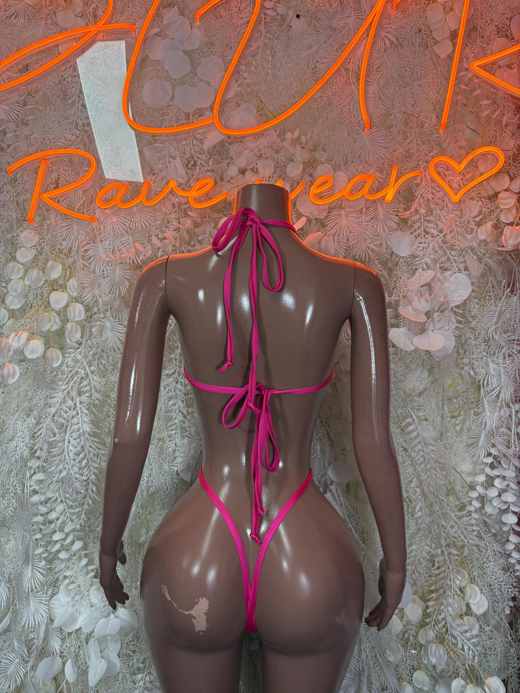 Heart-print lingerie one-piece back view, pink tie strings on sheer black