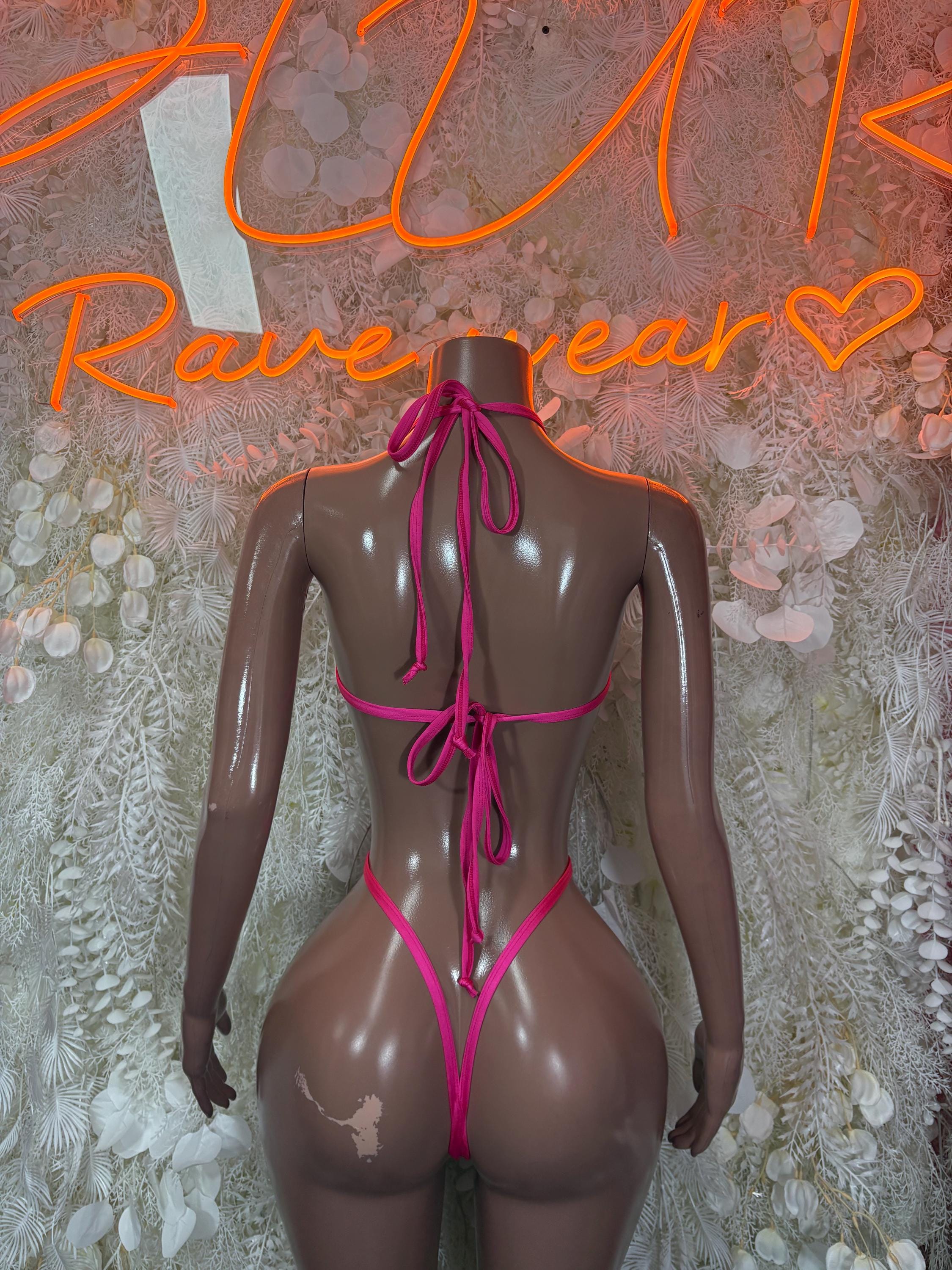 Heart-print lingerie one-piece back view, pink tie strings on sheer black