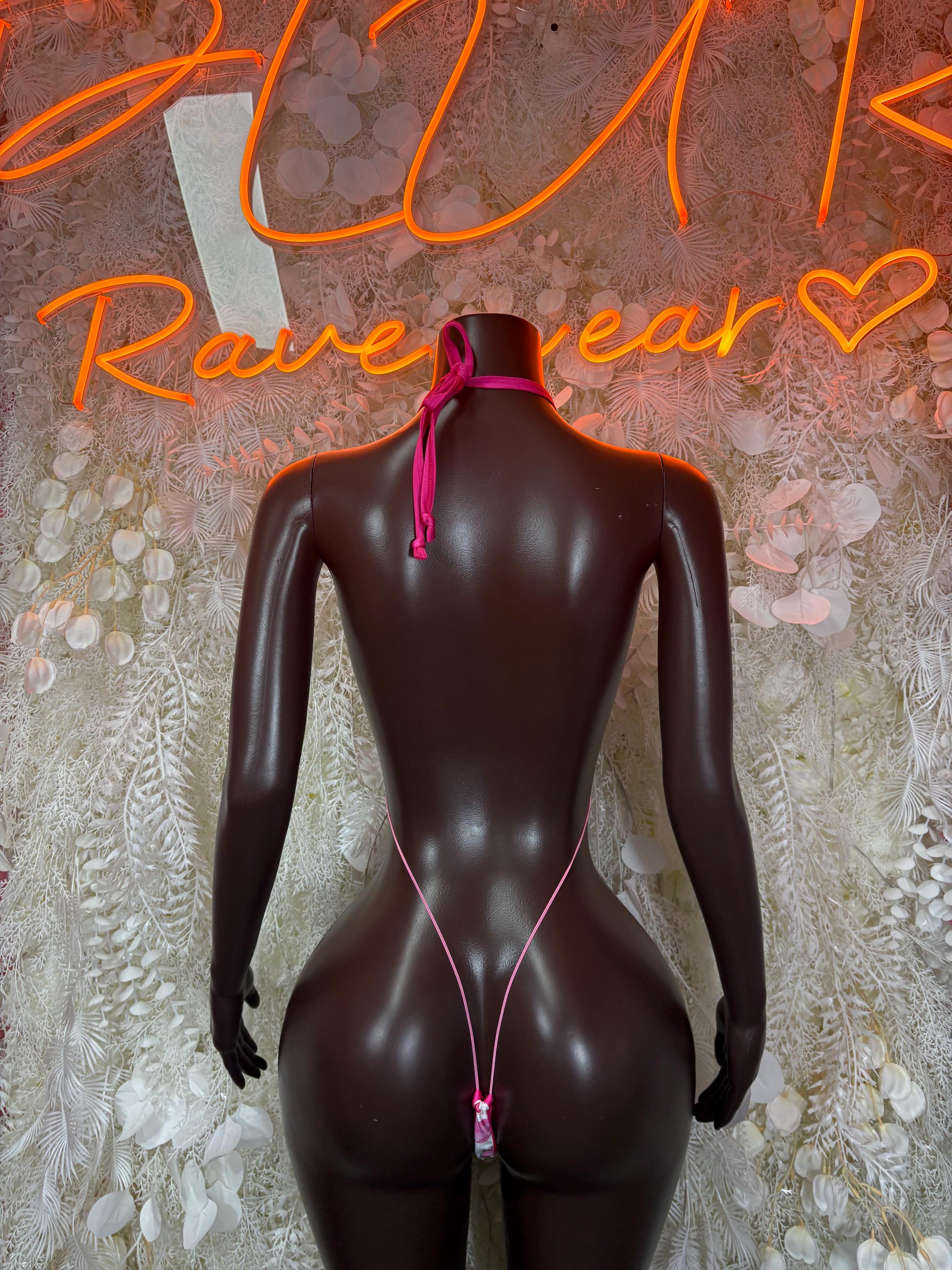 Black one-piece lingerie bodysuit with pink donut-style print, back view, thin tie straps