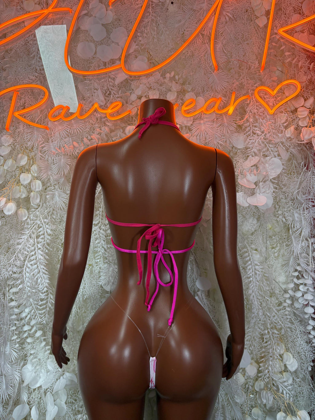 Back view of pink and white lingerie set with halter straps and crisscross lace tie