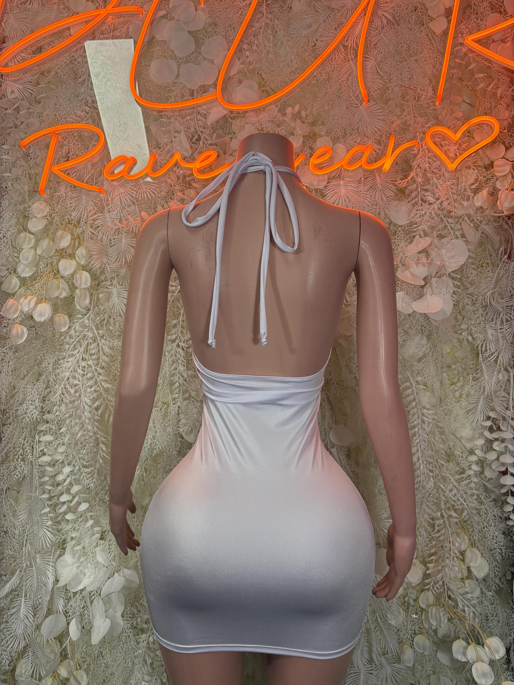 White halter mini dress with open back and tie straps, ruched sides