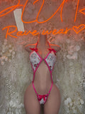 Pink and white patterned lingerie bodysuit with tie front and thong bottom