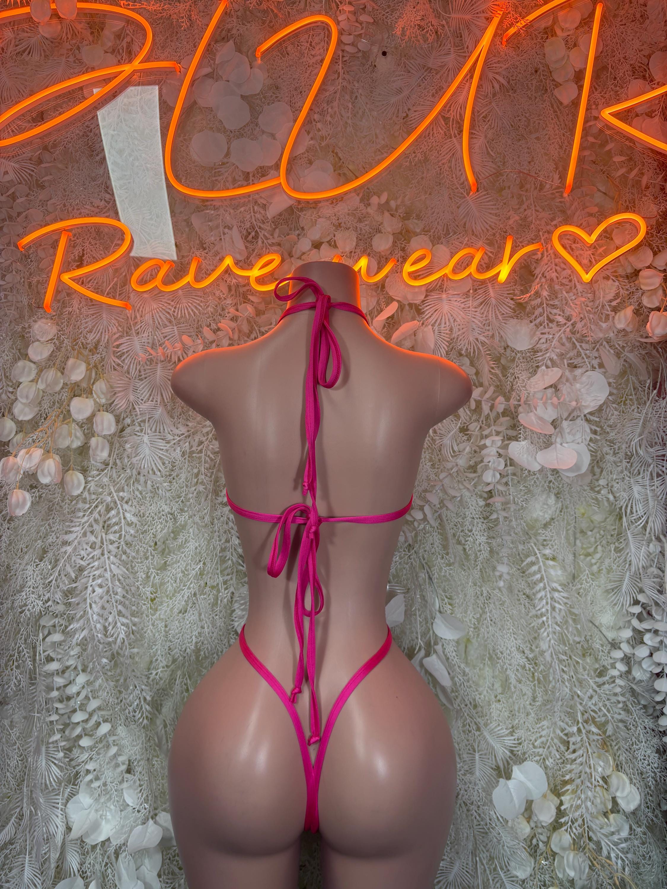 Pink lingerie bodysuit with crisscross back ties and thong back