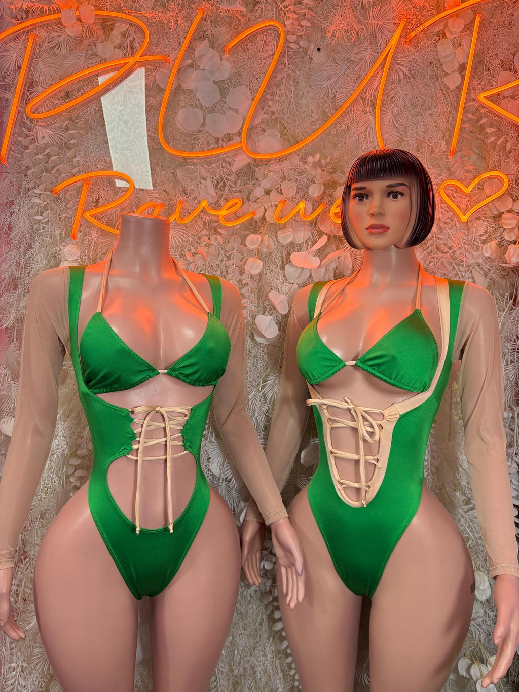 Green lace-up bodysuit with triangle cups and sheer long sleeves, front view