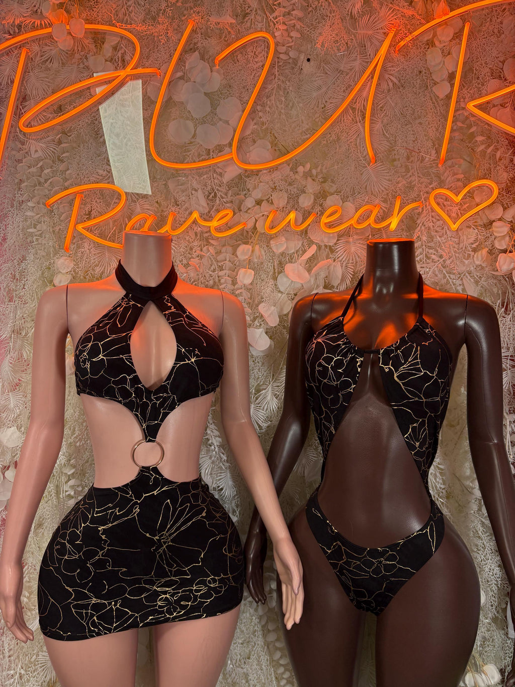 Black and gold web-pattern bodysuits on two models, one front and one back