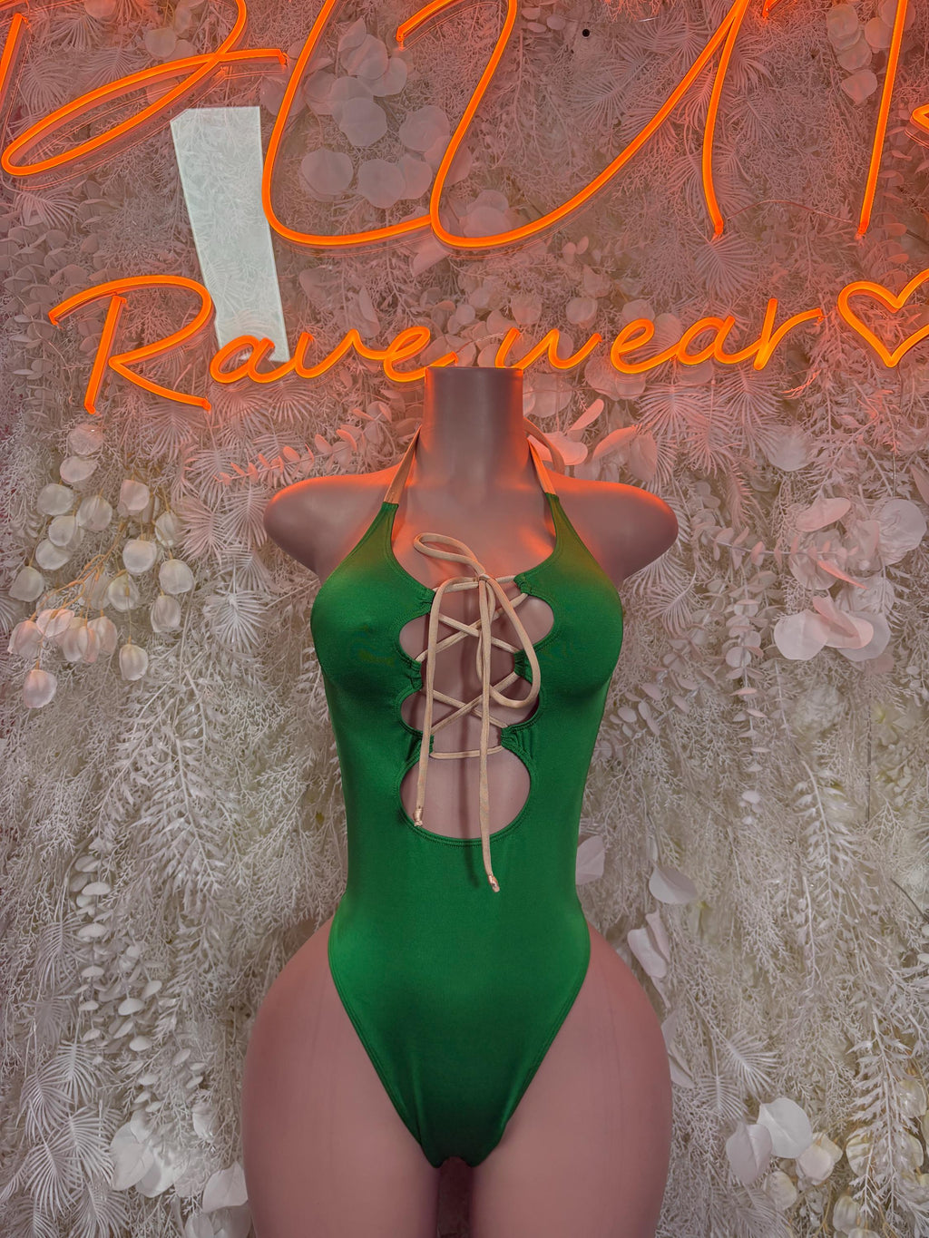 Green sleeveless bodysuit with halter straps and front lace-up tie