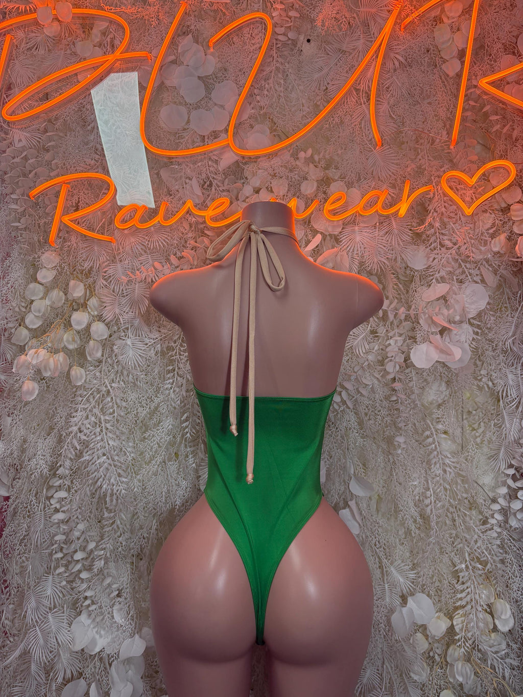 Green backless bodysuit with halter straps and crisscross lace-up back