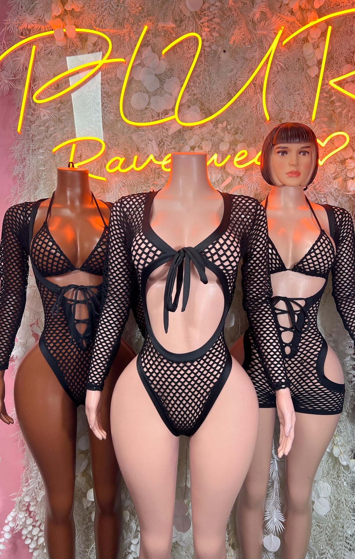 Black fishnet bodysuit with bow at chest, high-cut legs, long sleeves