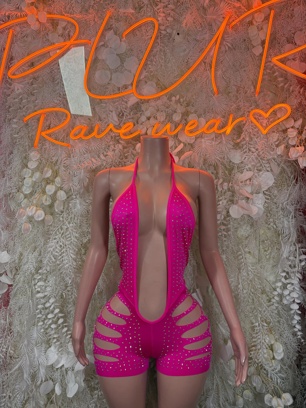 Pink rhinestone cutout bodysuit with strappy hip cutouts and deep V neckline