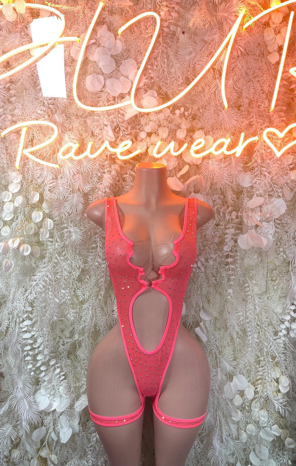 Pink rhinestone bodysuit with deep V neckline, center cutout, and high-cut legs