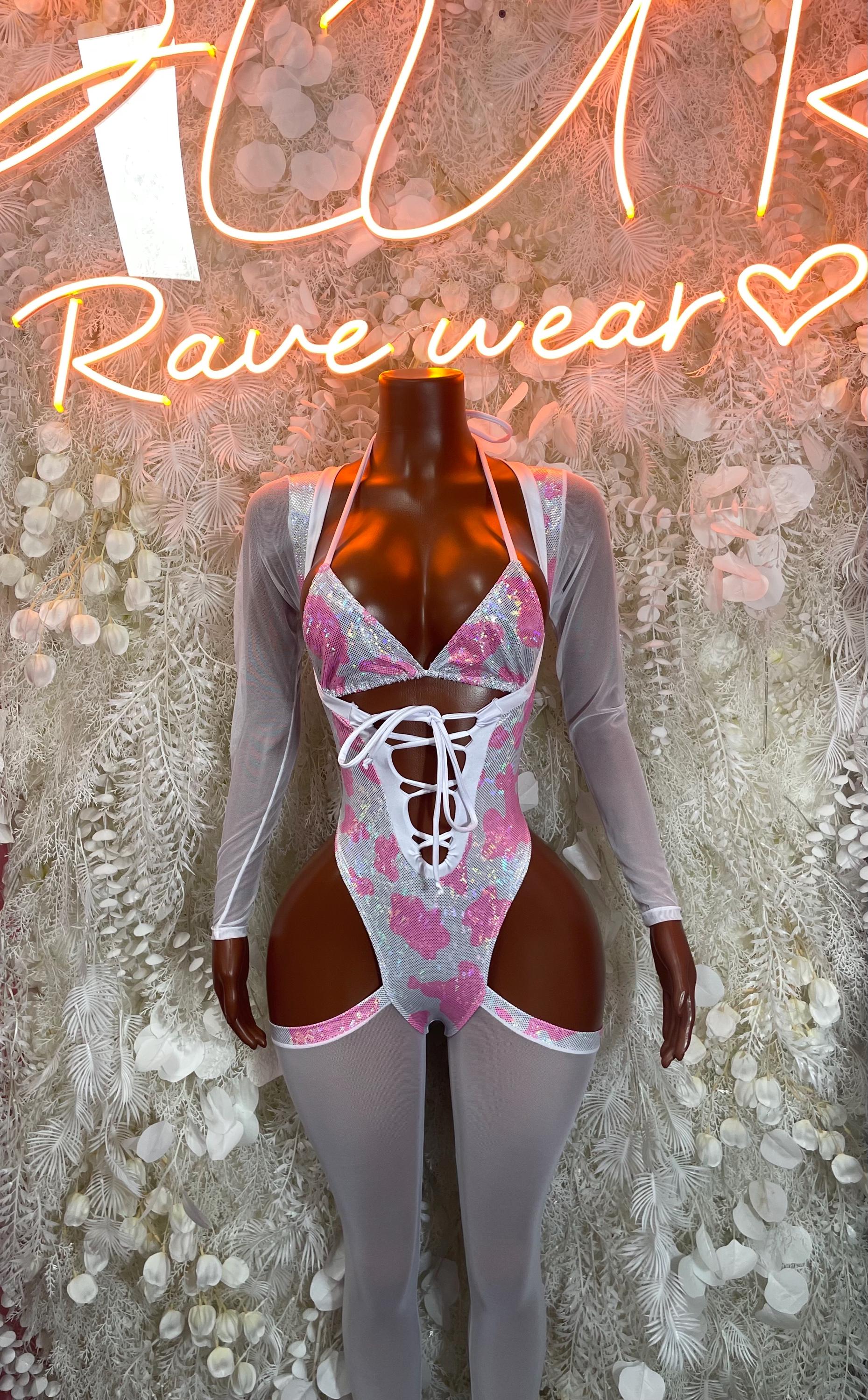 Pink cow print bodysuit with long sleeves and crisscross lace-up front