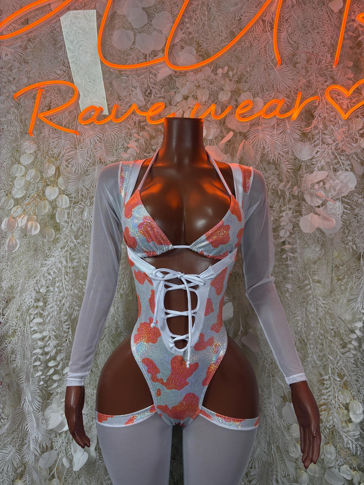 Bottlegirl cow print lace-up bodysuit with sheer long sleeves and cutout front