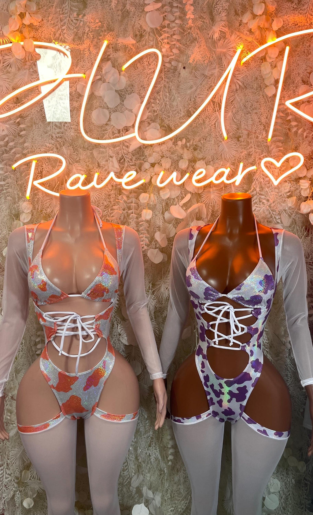 Two cow print bodysuits with long sheer sleeves, orange and purple, lace-up front cutouts