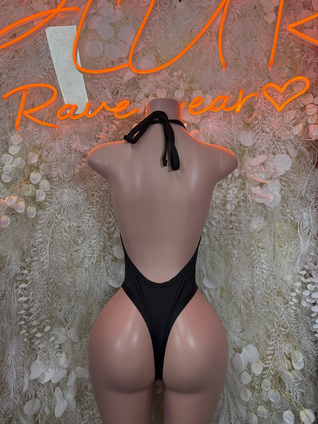 Black halter bodysuit with V-back and thong bottom, one-piece