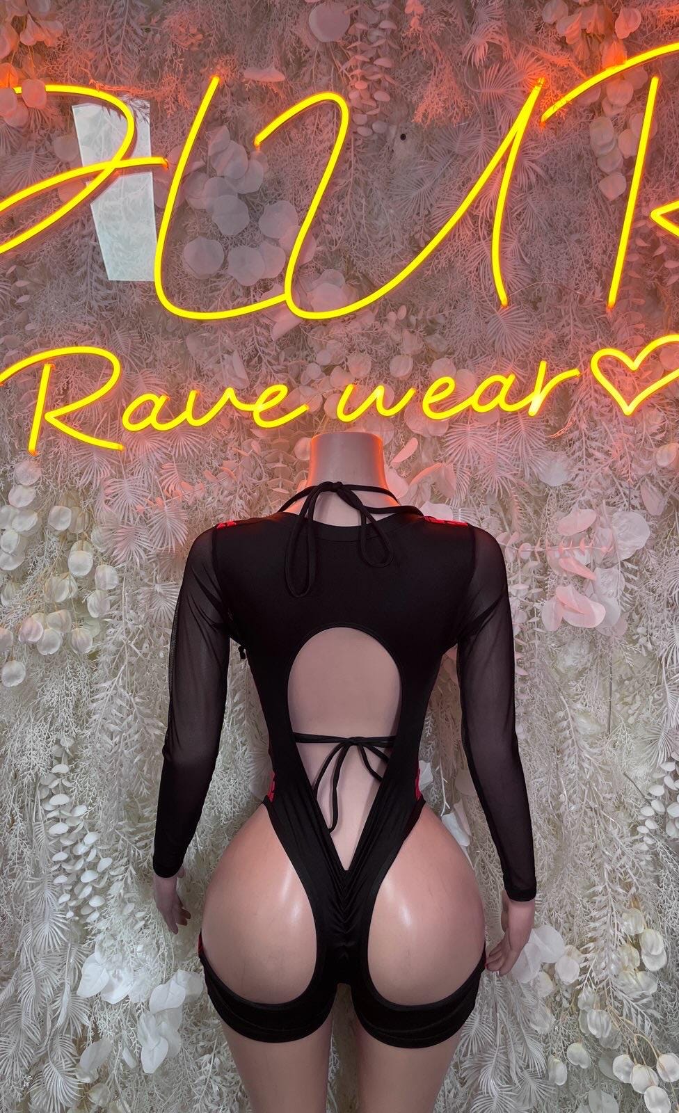 Black long-sleeve bodysuit with open back cutout and tie straps