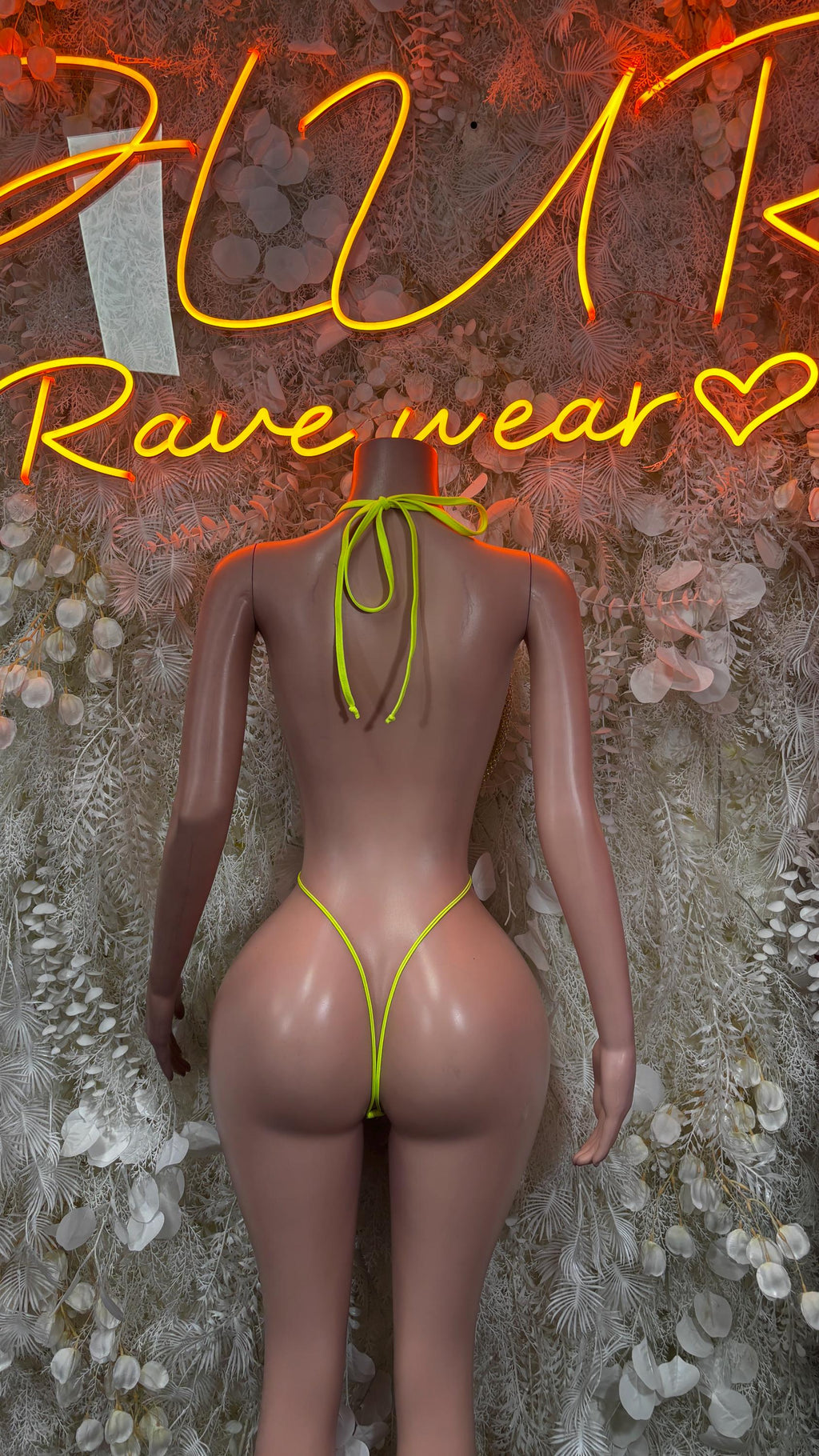 Neon green fishnet thong bodysuit with strappy back and triangle center